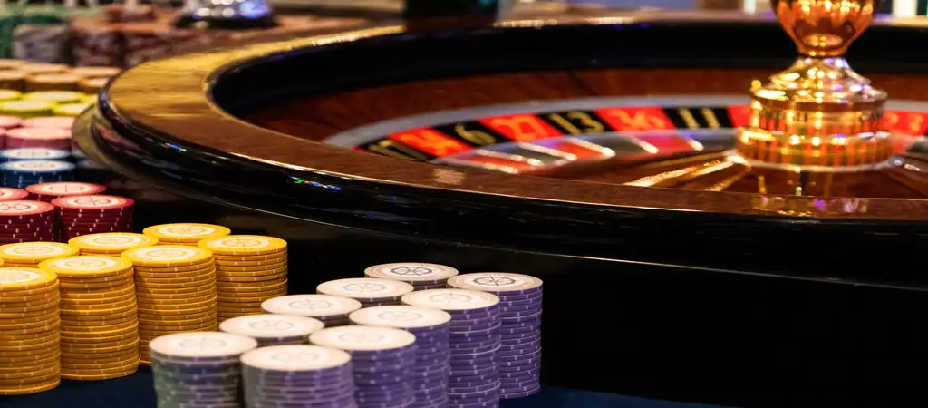 roulette table, poker chips, physical casino